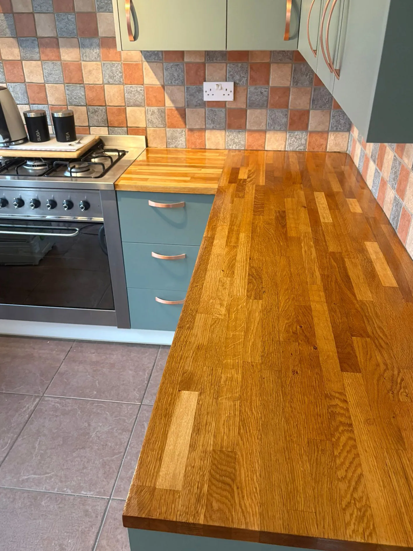Kitchen cabinet respray with copper handles and solid oak worktops