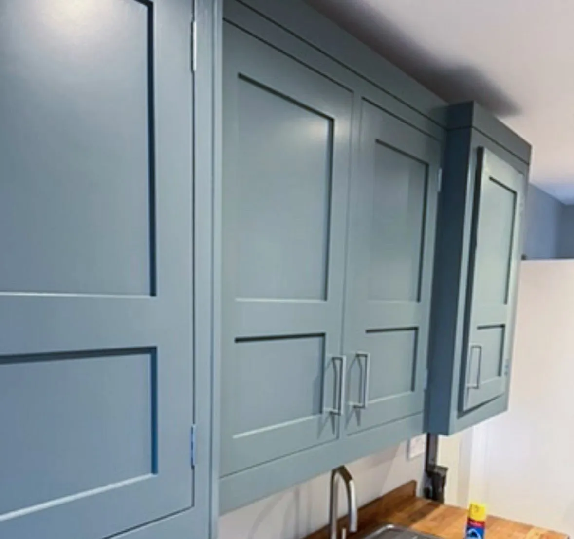 Close up of flawless blue kitchen cabinet spray finish in Shoeburyness