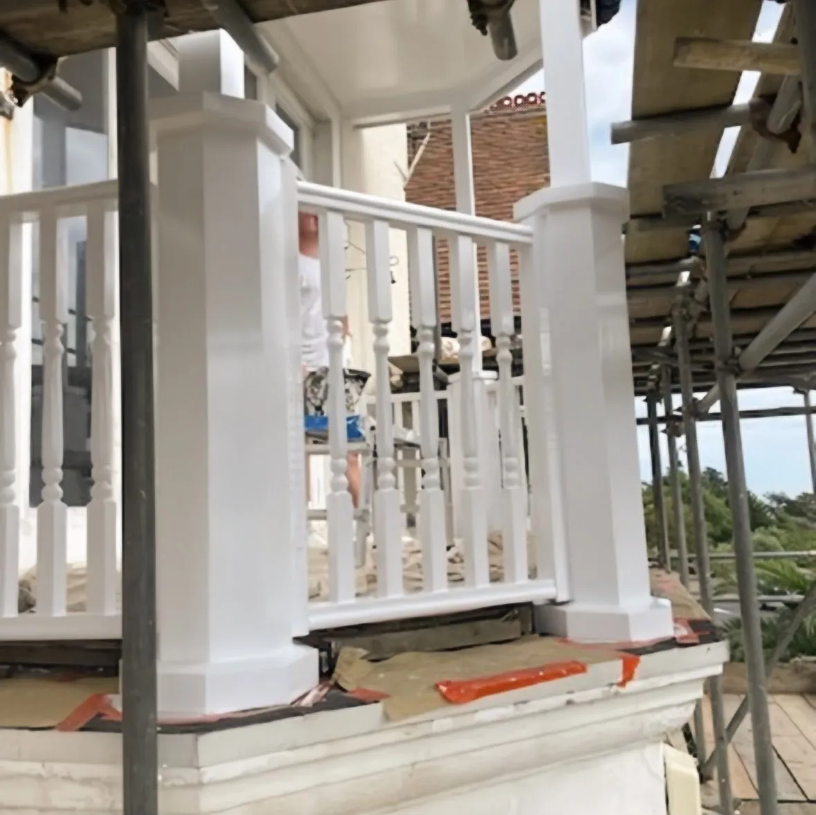 Professional exterior woodwork painting on a white balcony in Southend