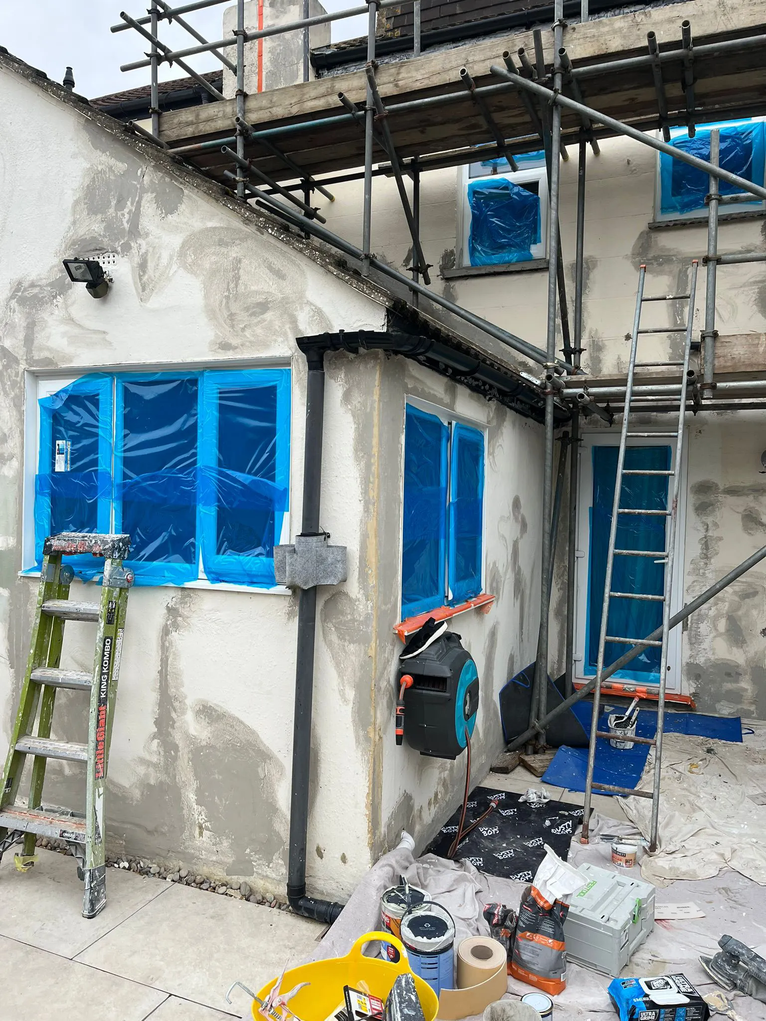 Exterior masonry painting and scaffolding setup for full house redecoration